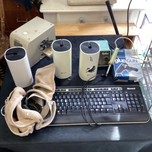 Tool lot featuring soldering irons, keyboard and tool belt.