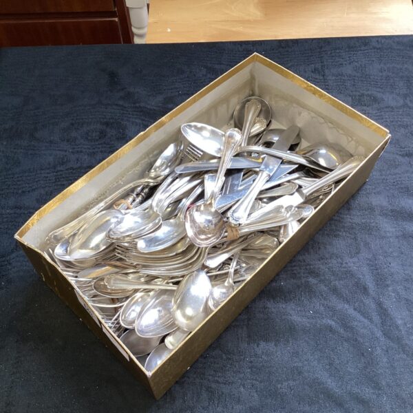 Mixed cutlery set in a cardboard box, vintage silverware.