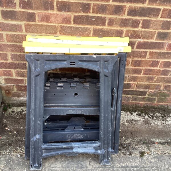 Metal folding saw trestles with black legs.