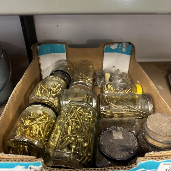 Jar of assorted brass effect screws for DIY projects.