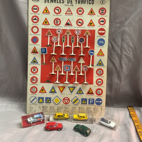 Red Herpa VW Golf models with Spanish road signs.