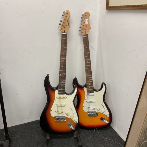 Two sunburst electric guitars, including a Peavey, presented as a lot.