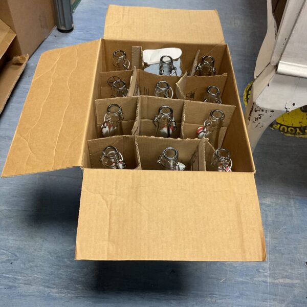 Box of twelve new sealable brewery glass bottles.