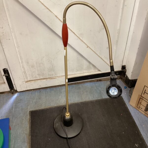 Vintage brass task lamp with flexible head and adjustable arm.