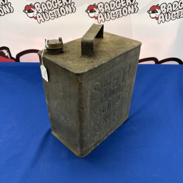 Front view of a vintage Shell fuel can with embossed lettering.
