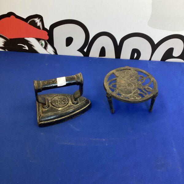 Antique smoothing iron with Bonzo trivet, vintage cast iron collectible.