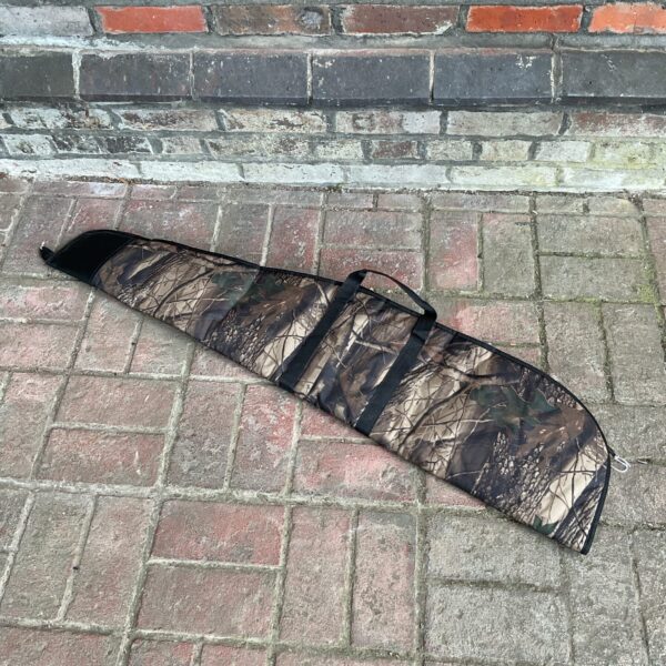 Camouflaged rifle case with carry handle for secure firearm transport.