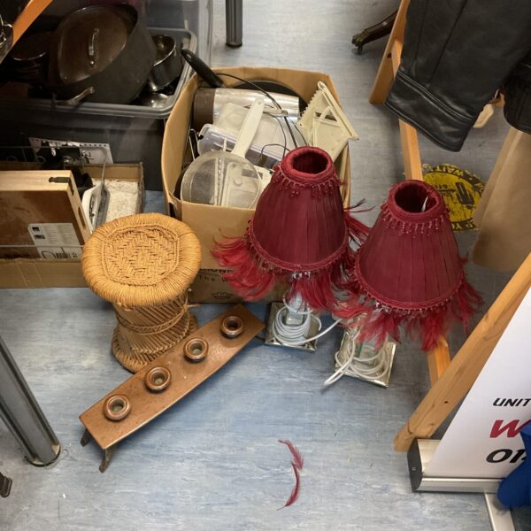 Two vintage table lamps with red fringed shades for home decor.