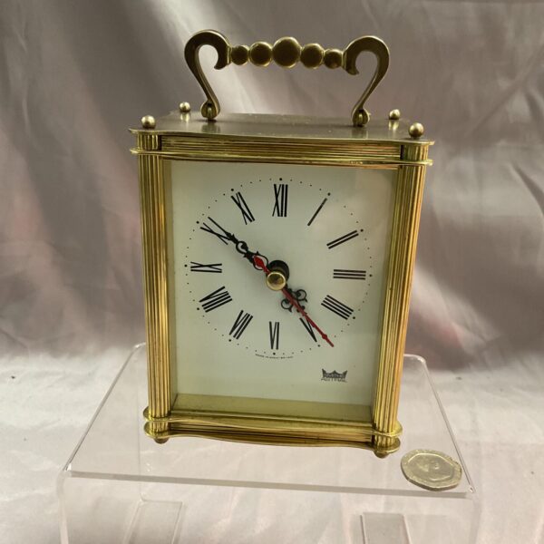 Vintage brass Astral quartz carriage clock with Roman numerals.