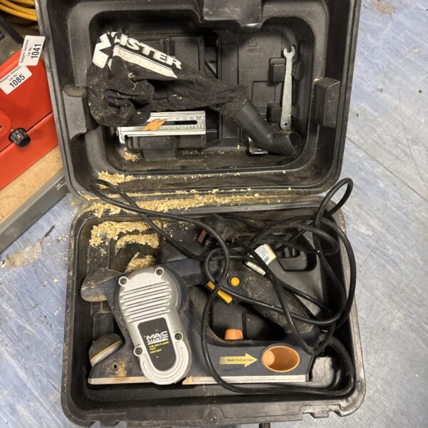 Macallister electric planer in open case, showing the tool and accessories.