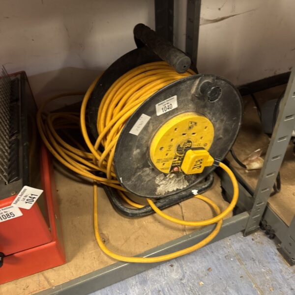 Yellow JCB 50m extension reel for portable power on site.