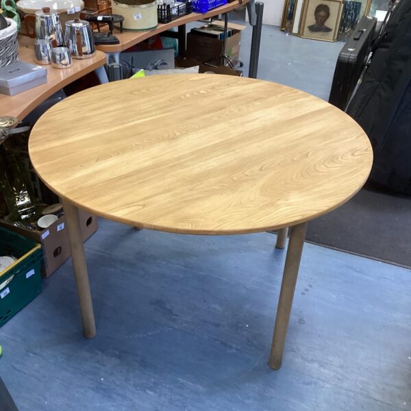 Large blonde wood Ercol round dining table, mid-century modern style.
