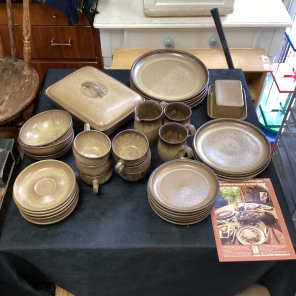 Vintage 1975 Denby stoneware dinner service set on display.