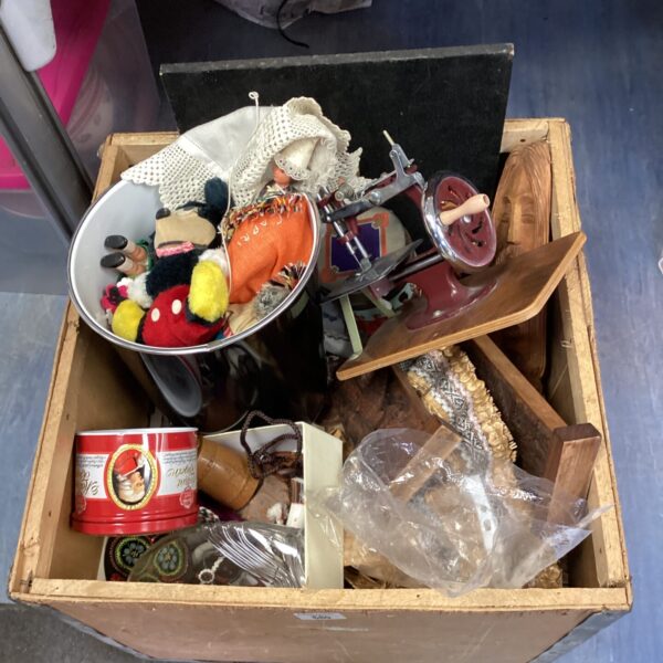 Vintage tea crate filled with a mixed lot of antique toys and ephemera.
