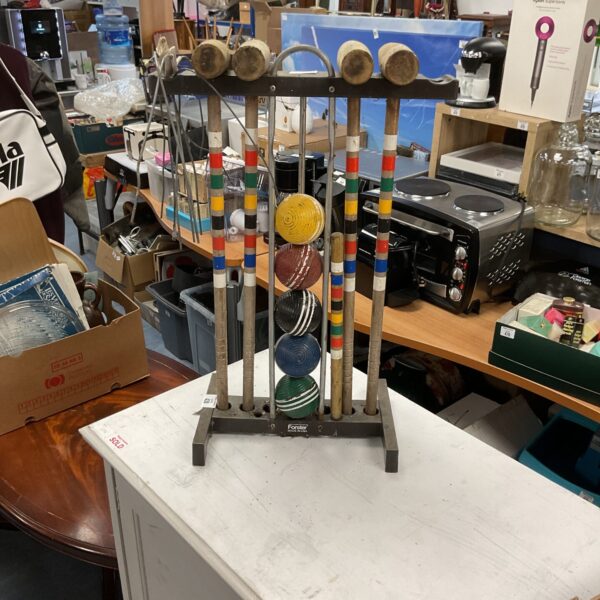 Vintage Foster croquet set on wooden stand, garden game.