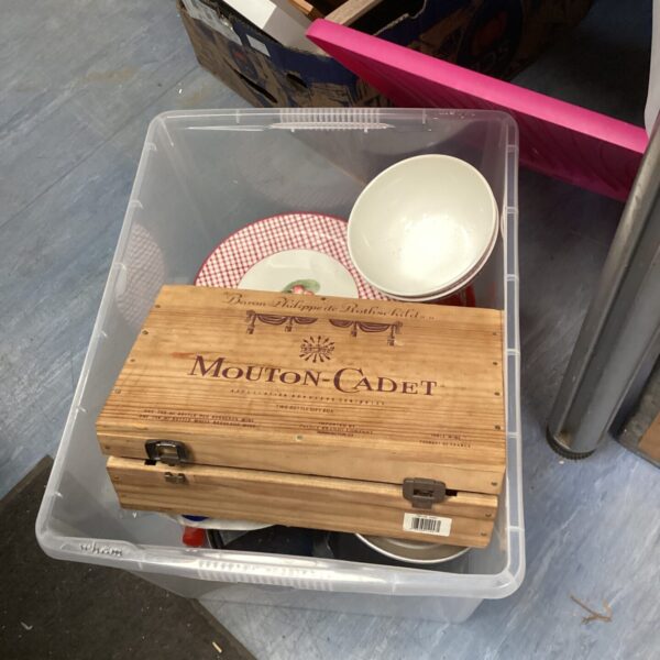 Mouton Cadet box filled with colourful plastic picnic plates and bowls.