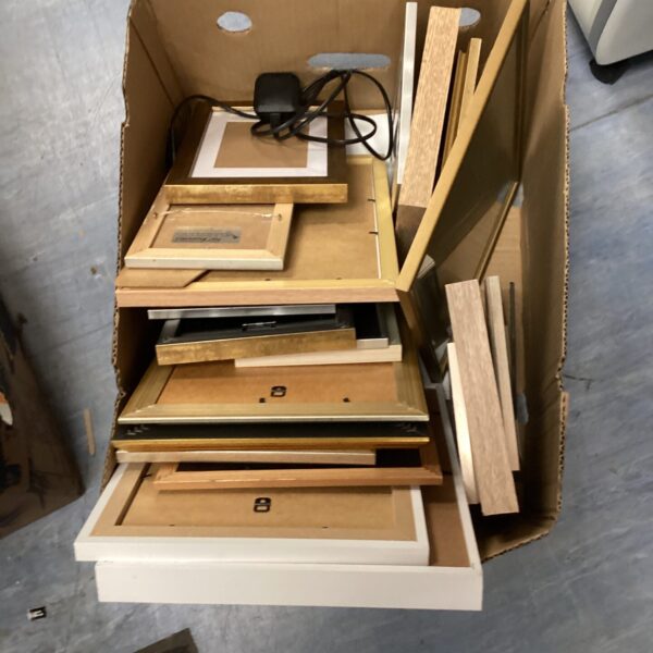 Mixed lot of vintage wooden picture frames for display.