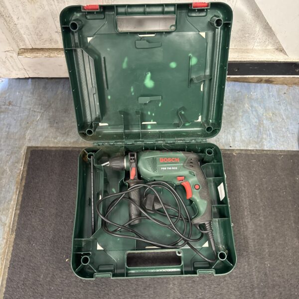 Open case of a vintage Bosch PSB 750 RCE hammer drill.
