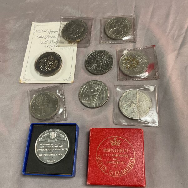 Collection of commemorative coins celebrating Queen Elizabeth.