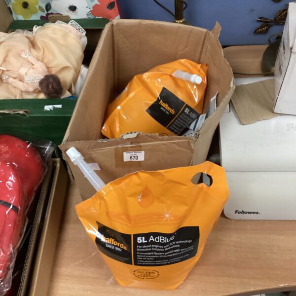 Two full 5L containers of AdBlue diesel exhaust fluid.