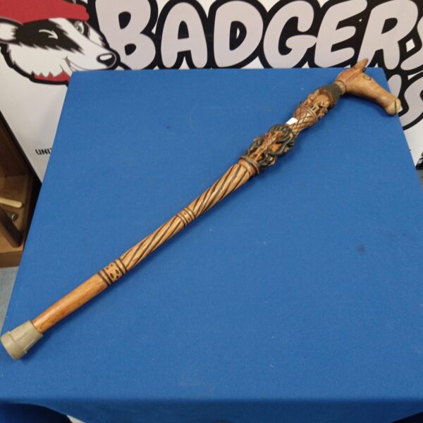 Intricate hand-carved African walking stick with animal motifs.
