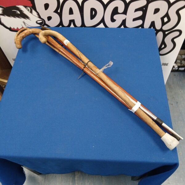 Vintage bundle of wooden walking sticks and canes for collectors.