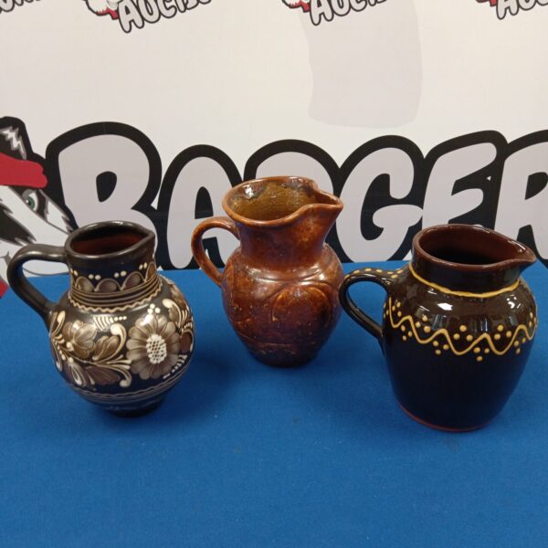 Vintage brown glazed art pottery jug with decorative detailing.