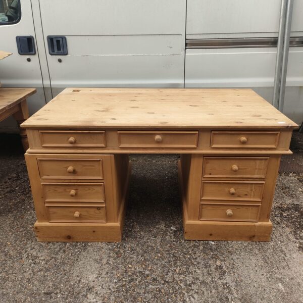 Large pine executive desk with six drawers, vintage office furniture.