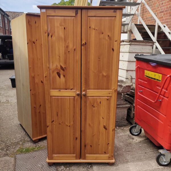 Front view of a vintage pine wardrobe with two doors.