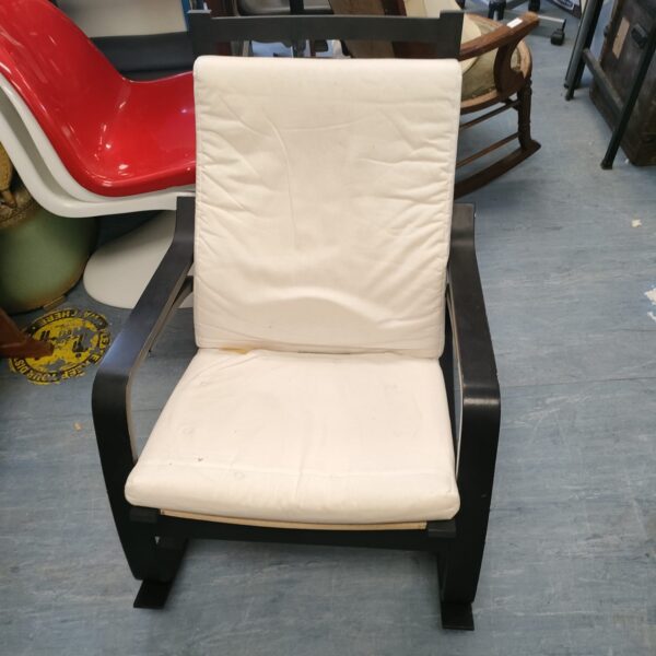 Modern wood rocking chair with neutral fabric upholstery.