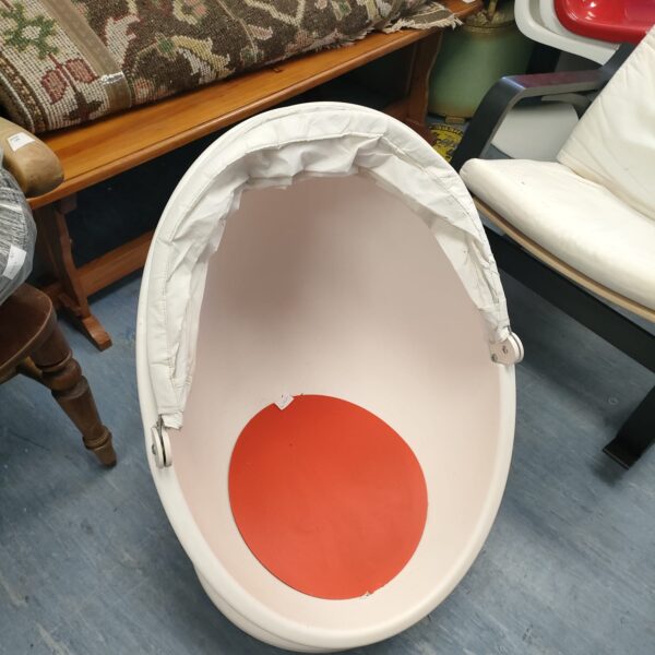 Side view of a white child's egg chair.