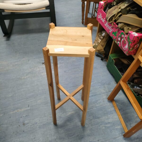 Vintage light wood jardiniere stand for plant display.