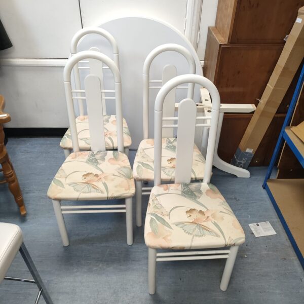 Vintage white dining chairs with floral upholstery for kitchen or dining room.