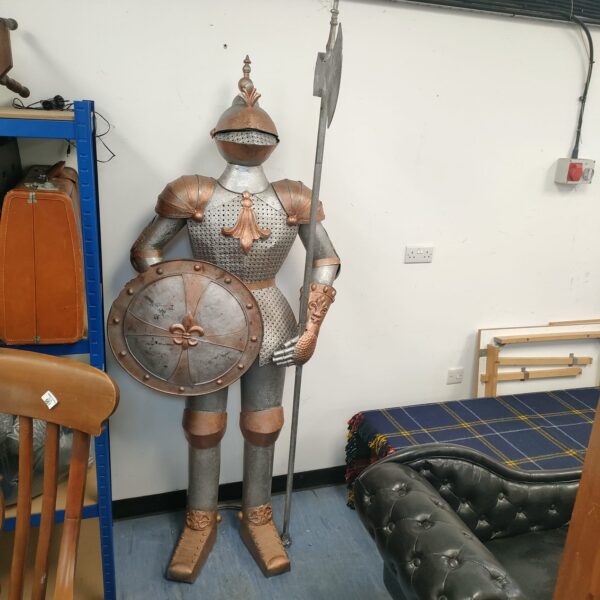 Large metal knight in full armour, medieval statue.