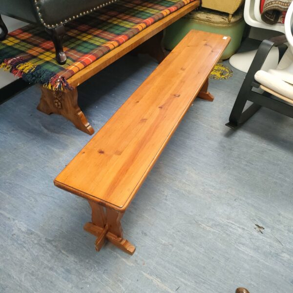 Rustic pine hallway bench with a simple wooden design.