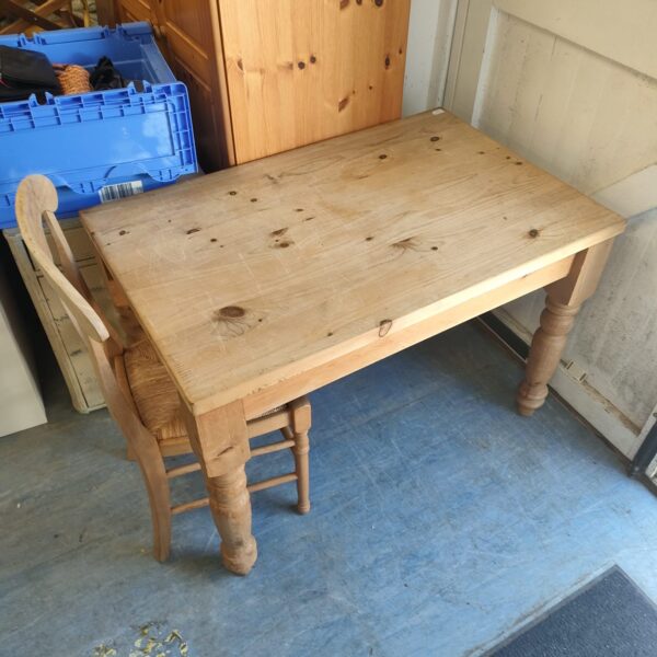 Vintage pine kitchen table and chairs in a rustic setting.