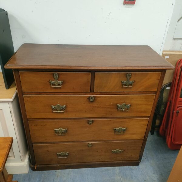 Antique mahogany chest of drawers with two over three configuration.
