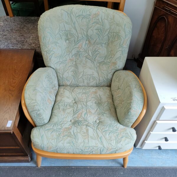 Vintage Ercol armchair with patterned fabric upholstery.