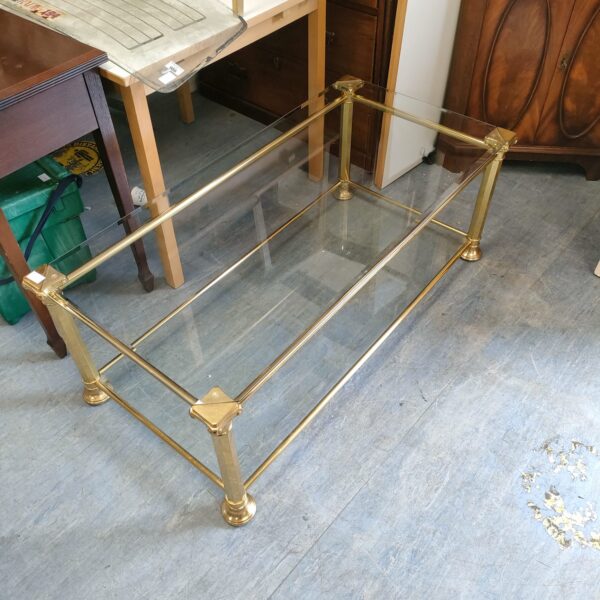 Vintage glass top coffee table with brass effect frame.