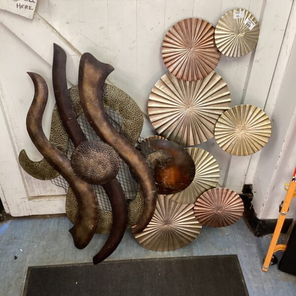 Abstract metal wall art sculpture with bronze and copper tones.