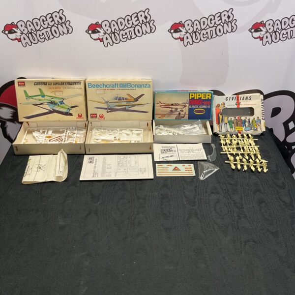 Vintage lot of four aircraft model kits, including Cessna and Beechcraft.
