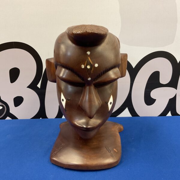 Large African carved bust with bone inlay details.