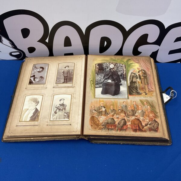 Open Victorian Gladstone photo album displaying antique photographs and embossed cover.
