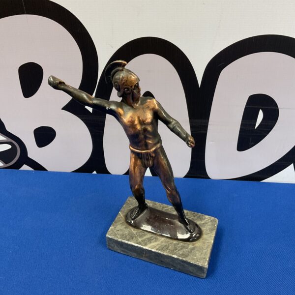 Detailed bronze sculpture of a Roman gladiator on a stone base.