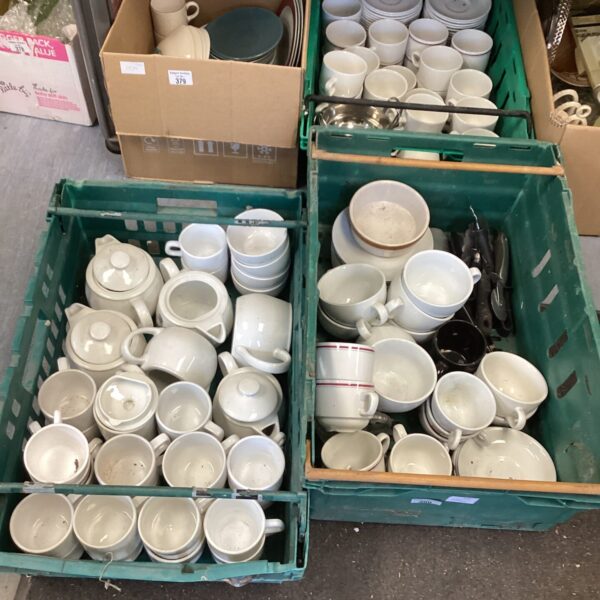 White commercial coffee cups stacked in trays, vintage catering ware.