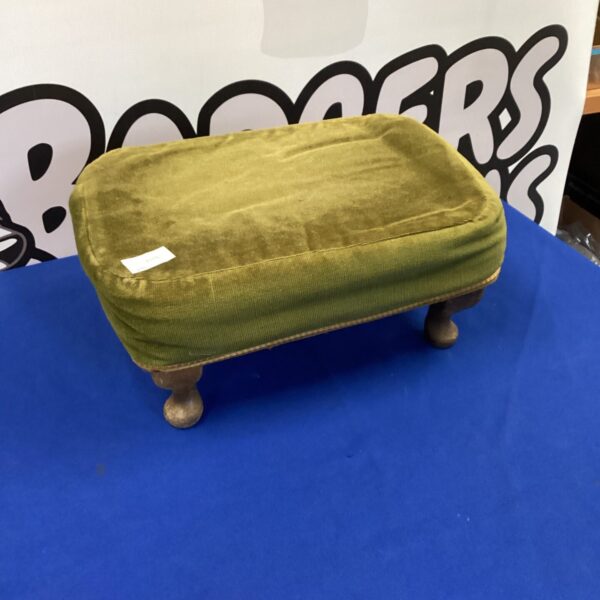Vintage green footstool with turned wooden legs.