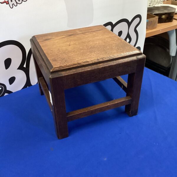 Vintage oak foot stool with a warm wood grain.