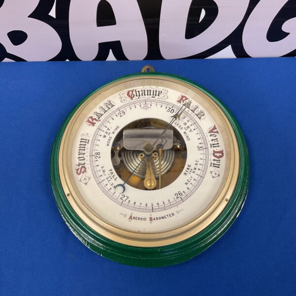 Large vintage brass android barometer for weather forecasting.