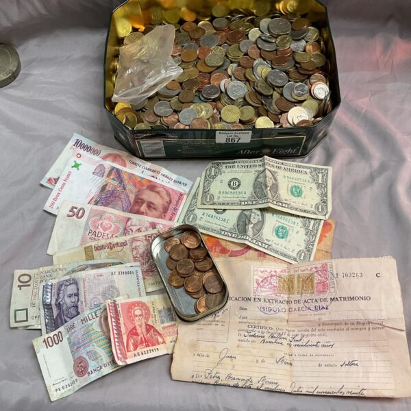 Assorted world currency lot with banknotes and coins.