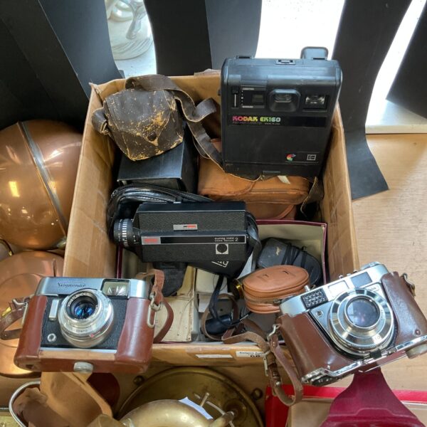 Vintage camera lot featuring a Kodak Eumig and other retro cameras.
